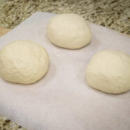 Boules of each loaf, about the size of a baseball before rising. Marked on the parchment with pencil which is which.