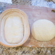 Dough shaped and in banneton and one waiting its turn.